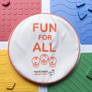 An assembled Reach and Match kit with the "FUN FOR ALL" tile carrying case placed in the center.