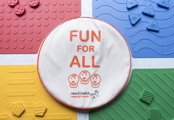 An assembled Reach and Match kit with the "FUN FOR ALL" tile carrying case placed in the center.