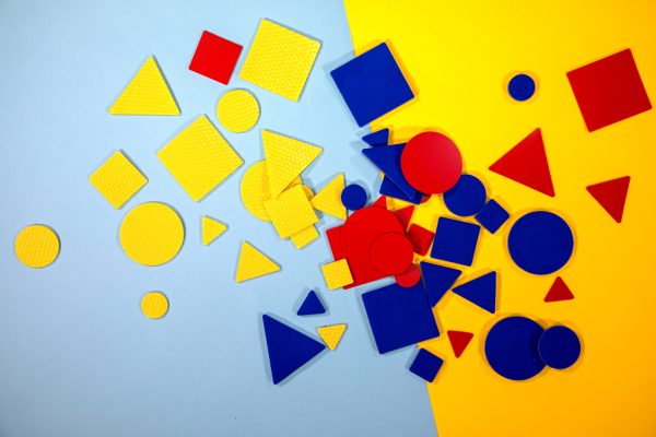 Square, triangle, and circle manipulatives in a variety of sizes and colors (red, blue, and yellow).