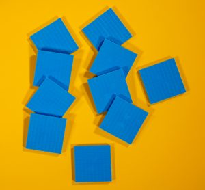 Ten flat blue squares arranged in two rows on a yellow background.