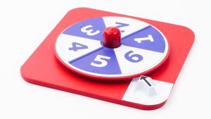 Overhead shot of the red hop-a-dot number spinner on a white background. The spinner alternates between white and blue.