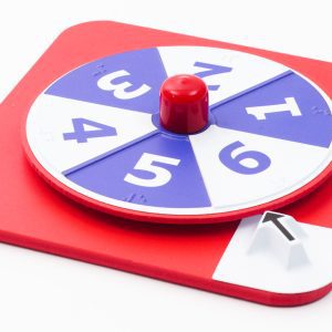 Overhead shot of the red hop-a-dot number spinner on a white background. The spinner alternates between white and blue.