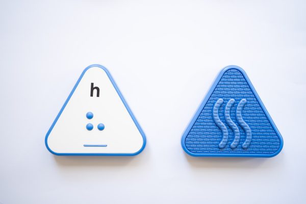 The front and back of a blue, triangular Reach & Match Alphabet Tile showing the letter h in print and braille.