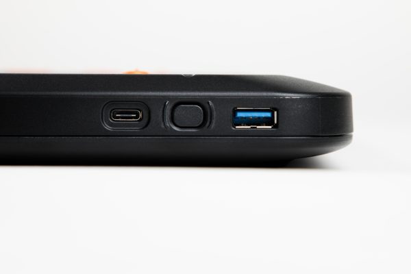 A close-up of the left edge of the Monarch device showing from top to bottom a USB-C port, the power button, and a USB-A port.