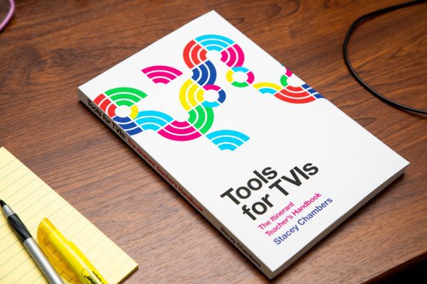 Printed copy of Tools for TVIs on a wooden desk.