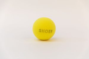 A yellow tennis ball with the word 
