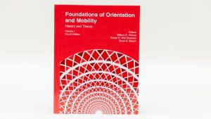 Foundations of Orientation and Mobility, Volume I: History and Theory, 4th edition sitting against a white background. The bottom half of the red cover features a geometric graphic.