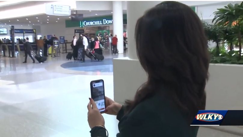 A woman using GoodMaps at an airport.