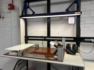 A desk with a table on one end, and a smartphone stand on the other. 